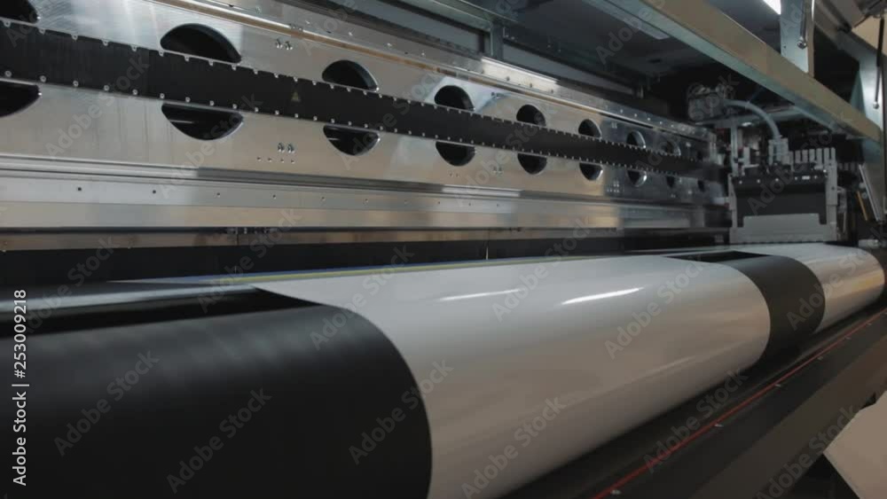 Details of a moving print head. Massive machinery. Professional printing facility, big vinyl rolls, ready for export. Glossy, matte, ecological materials used for commercial billboards and press. Details of a moving print head. Massive machinery. Professional printing facility, big vinyl rolls, ready for export. Glossy, matte, ecological materials used for commercial billboards and press.