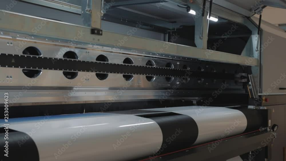 Details of a moving print head. Massive machinery. Professional printing facility, big vinyl rolls, ready for export. Glossy, matte, ecological materials used for commercial billboards and press. Details of a moving print head. Massive machinery. Professional printing facility, big vinyl rolls, ready for export. Glossy, matte, ecological materials used for commercial billboards and press.