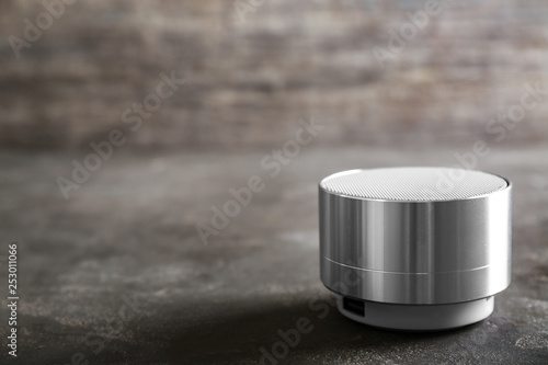 Smart home assistant device on grey table © Pixel-Shot