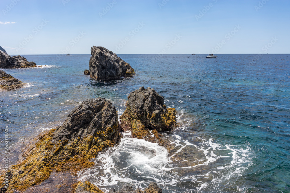 Italy, Cinque Terre, Manarola, a rocky shore next to a body of water