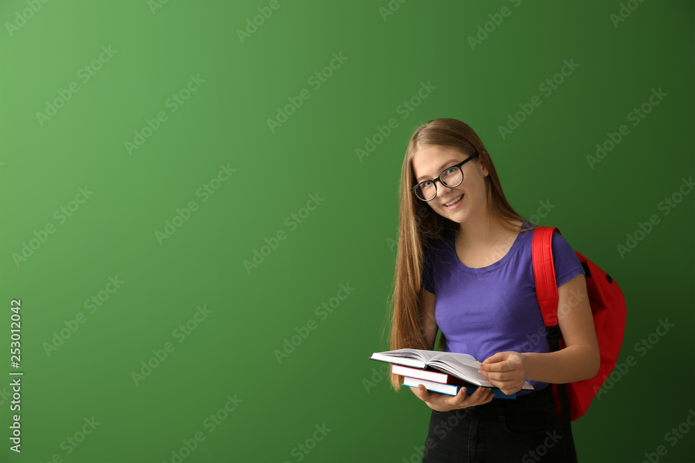 Schoolgirl with books on color background Schoolgirl with books on color background
