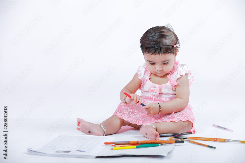 Cute little Indian/Asian Girl enjoying Painting with paper, colour pencle and art brush Cute little Indian/Asian Girl enjoying Painting with paper, colour pencle and art brush