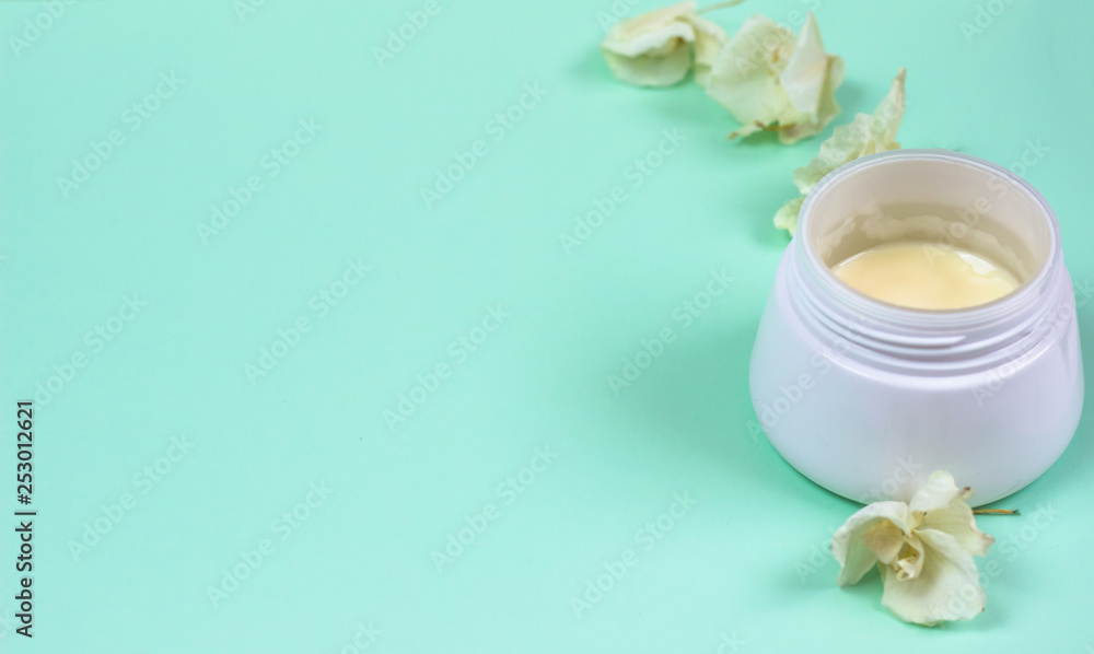 Natural cosmetic products on a blue background..A jar of natural cosmetic cream Natural cosmetic products on a blue background..A jar of natural cosmetic cream