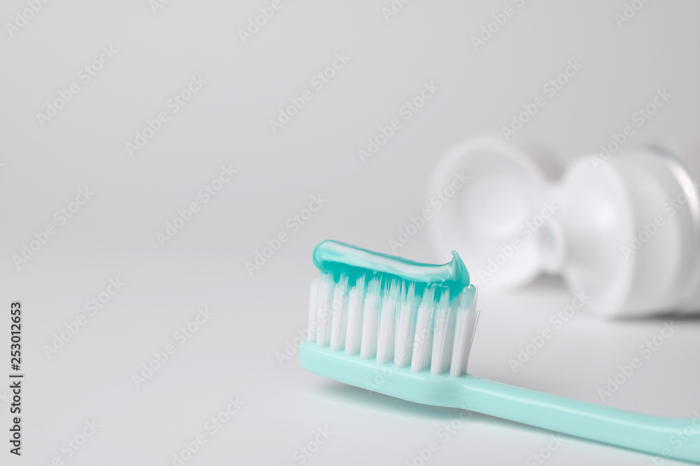 Toothbrush and toothpaste on blurred background Toothbrush and toothpaste on blurred background