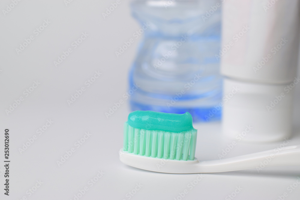 Toothbrush and toothpaste on blurred background Toothbrush and toothpaste on blurred background