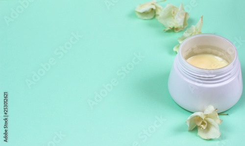 Natural cosmetic products on a blue background..A jar of natural cosmetic cream
