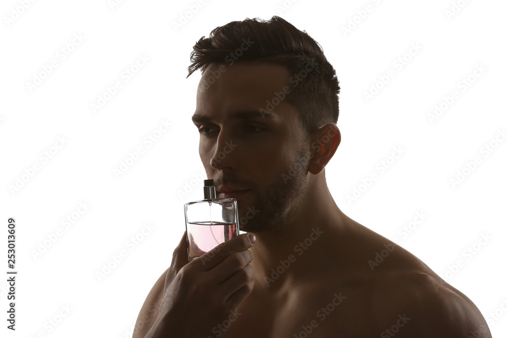 Silhouette of handsome man with bottle of perfume on white background Silhouette of handsome man with bottle of perfume on white background