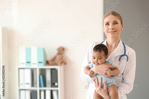 Pediatrician with African-American baby in clinic