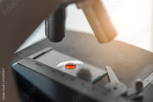 Microscope with blood droplet on glass for medical research