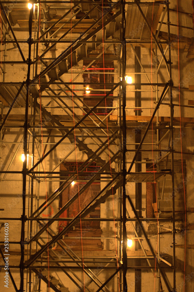 Scaffolding and industrial lights in diagonal pattern in Chelsea, Manhattan, New York City at night