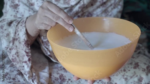 Woman preparing camel milk in the Sahara refugee camp photo