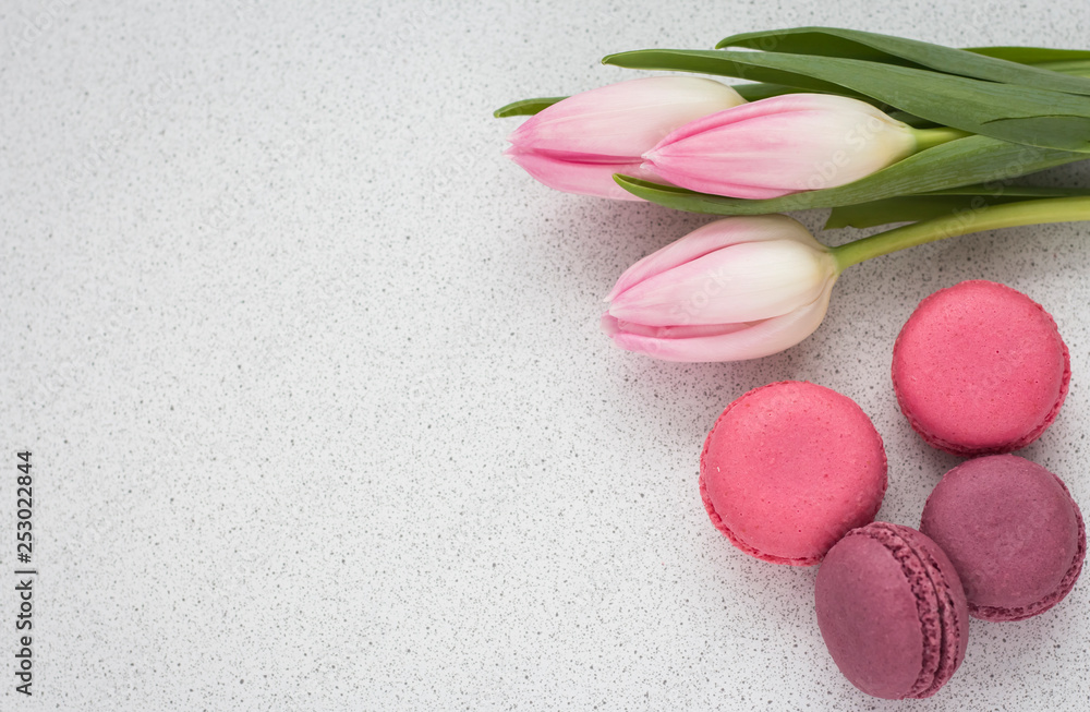 delicate tulips and macaroons on white background with copy space delicate tulips and macaroons on white background with copy space