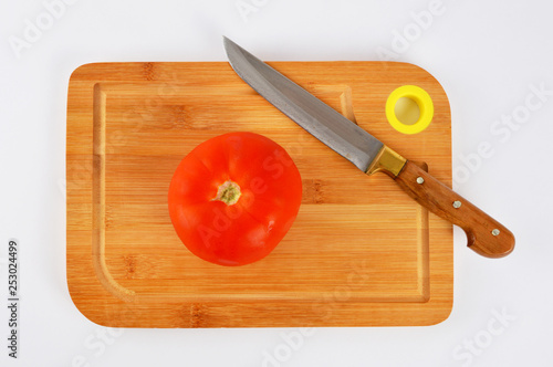 Knife and tomato on cutting board
