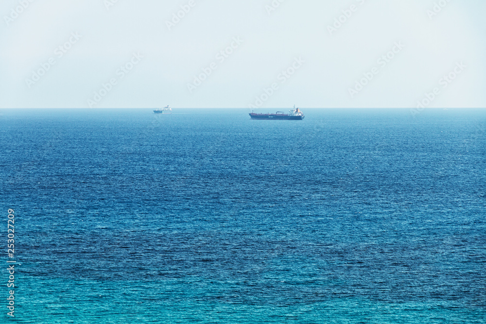 mediterranean sea and cargo ship on horizon in Spain