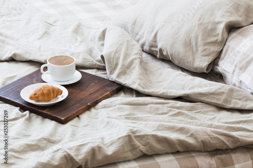 coffee on tray on the bed in bedroom