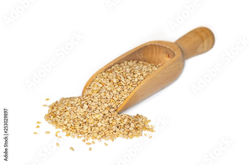Closeup of sesame seeds, a plant based source of calcium and iron, presented on a small wooden scoop