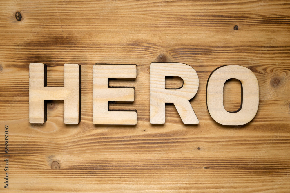 HERO word made of wooden block letters on wooden board. HERO word made of wooden block letters on wooden board.