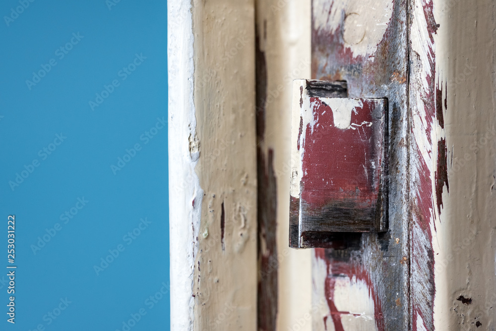 old door with red lock close up in front of a blue background