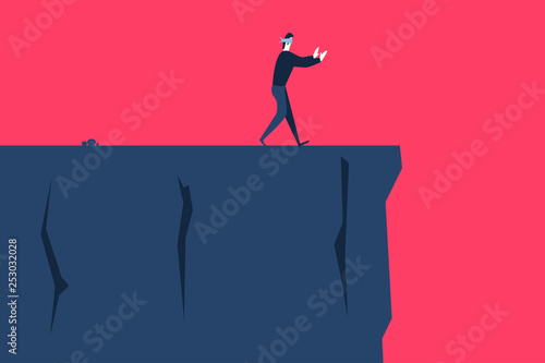 A blindfolded man goes to the cliff