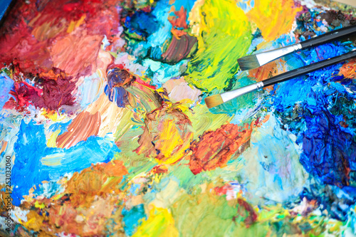 Color background of the artist's palette with brushes.