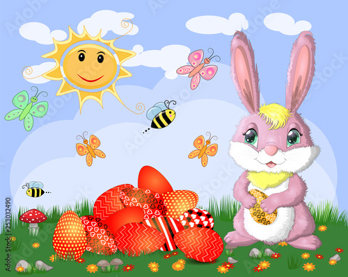 Easter bunnies near the basket with Easter eggs in the meadow, the sun, butterflies, spring. Copy space