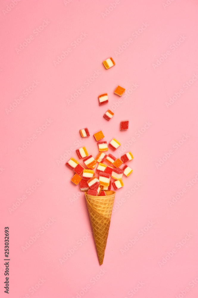 Flat lay : Ice cream cone with colorful party streamers on yellow background with copy space Flat lay : Ice cream cone with colorful party streamers on yellow background with copy space