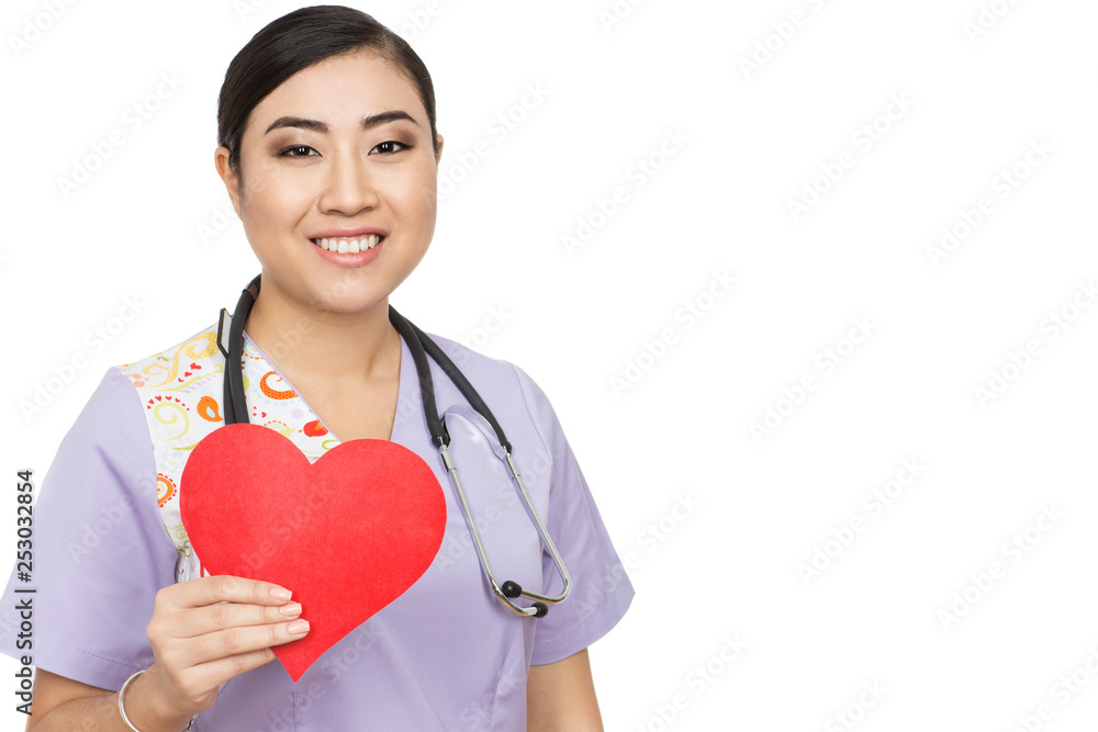 Caring for you. An attractive Asian female doctor holding red paper heart smiling warmly to the camera isolated on white Caring for you. An attractive Asian female doctor holding red paper heart smiling warmly to the camera isolated on white