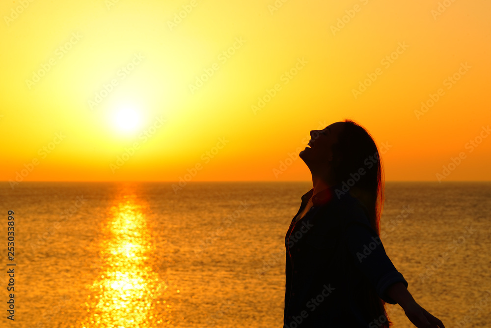 Happy woman on the beach breathing at sunset Happy woman on the beach breathing at sunset