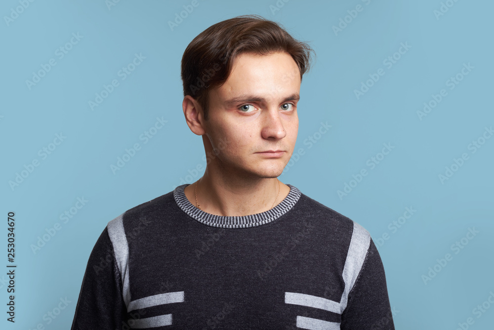 Calm man looking at camera isolated over blue Calm man looking at camera isolated over blue