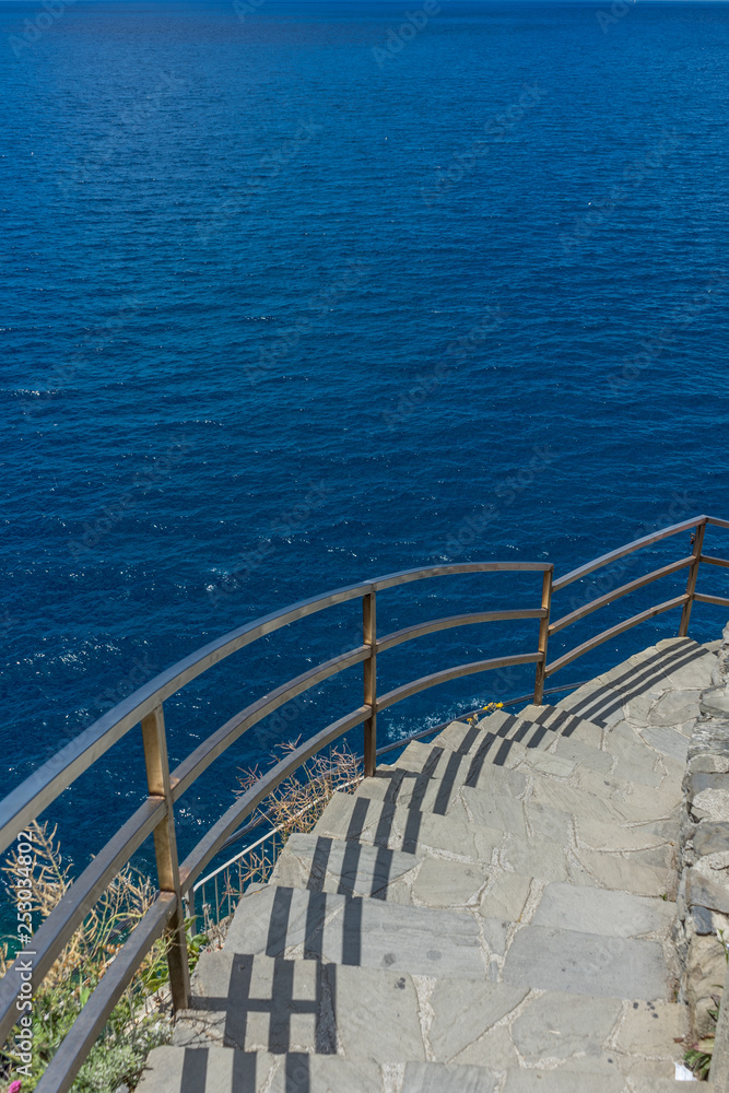 Italy, Cinque Terre, Manarola, a bridge over a body of water Italy, Cinque Terre, Manarola, a bridge over a body of water