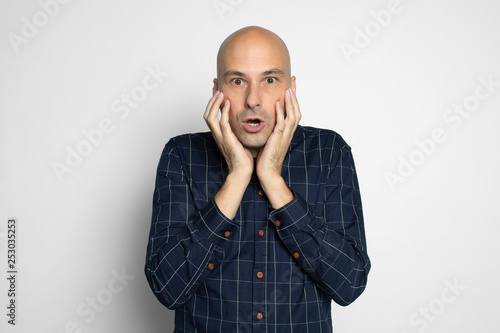 shocked man covering mouth with hands