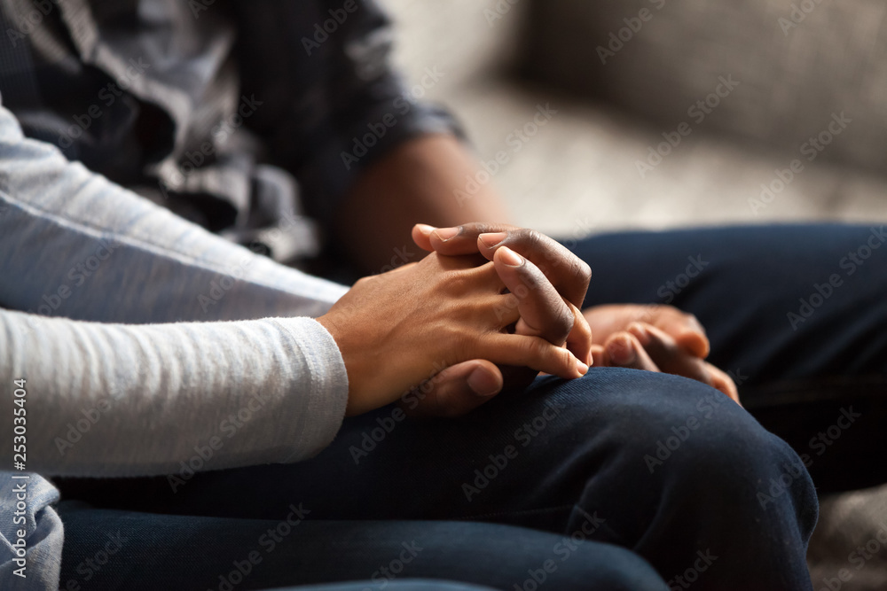 Close up of mixed race couple relax holding hands