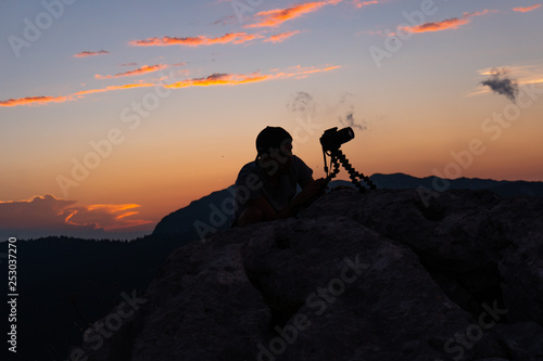 Photographer on mountain sunset