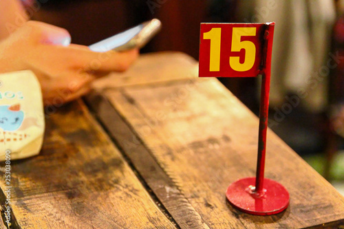 Ordering number on table at a restaurant. Waiting for order in the restaurant.