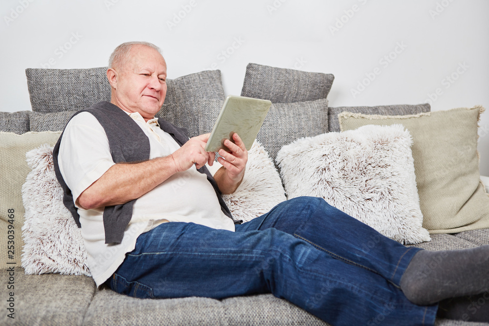 Fototapeta premium Man as senior relaxing at home