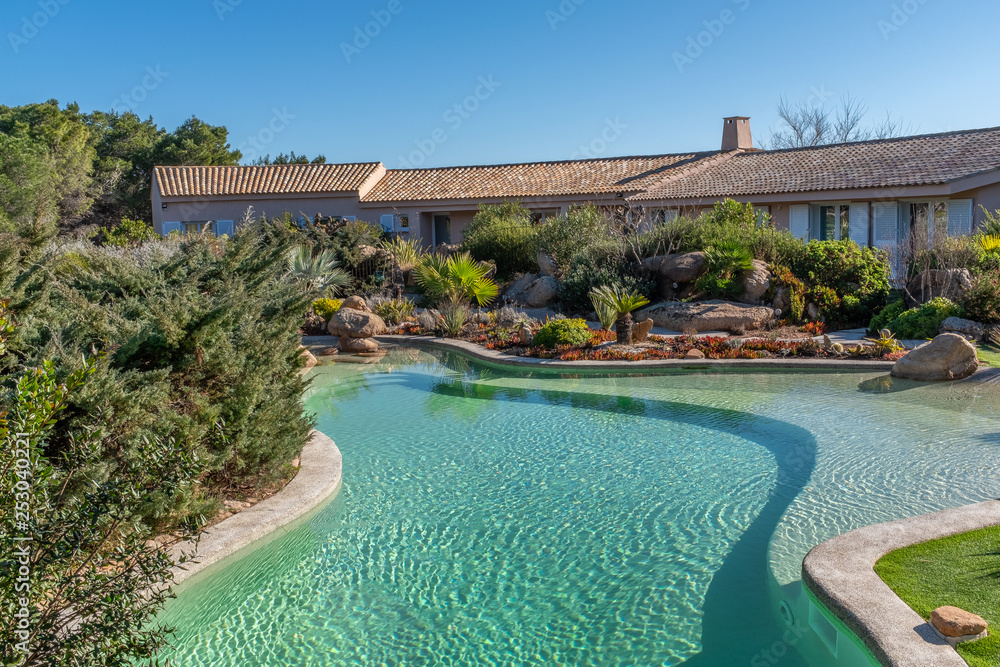 view blue swimming pool outdoor resort on blue sky landscape Corsican Maquis background.