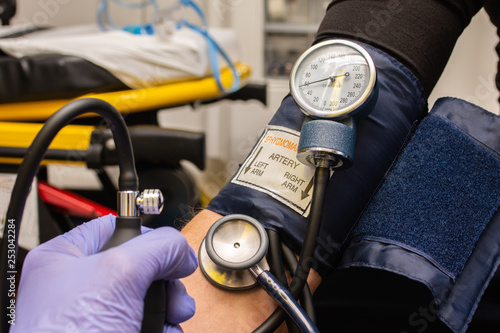closeup of professional checking blood pressure to patient in an ambulance