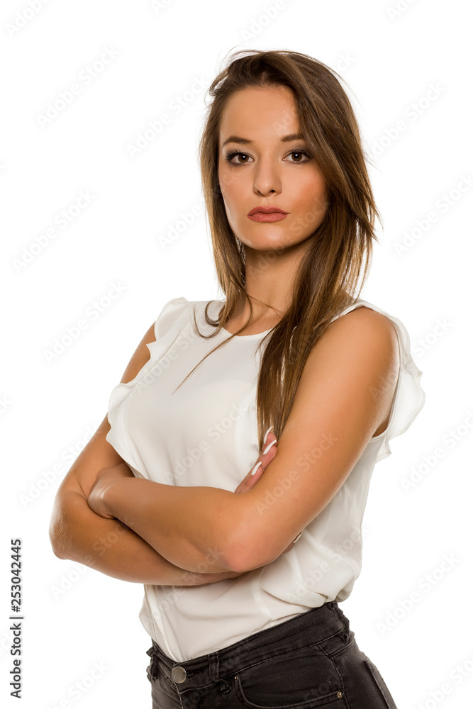 Portrait of young beautiful woman with crossed arms on white background Portrait of young beautiful woman with crossed arms on white background