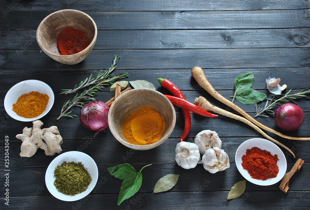 Colorful various of fresh and dried herbs, spices for cooking. Spice and herb seasoning, paprika powder, cinnamon, red onion. garlic, basil, ginger root on dark background Colorful various of fresh and dried herbs, spices for cooking. Spice and herb seasoning, paprika powder, cinnamon, red onion. garlic, basil, ginger root on dark background