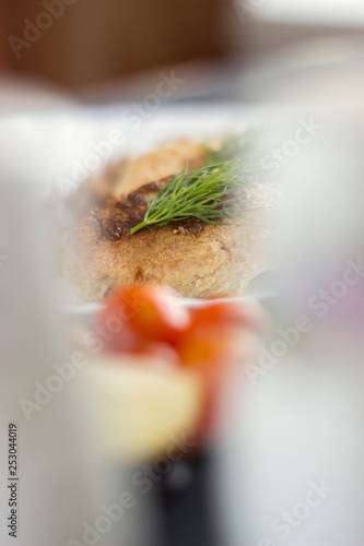 Fototapeta Naklejka Na Ścianę i Meble -  Chicken cutlets with herbs, ketchup and tomatoes