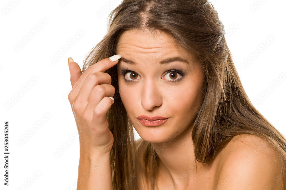 confused beautiful woman on a white background confused beautiful woman on a white background
