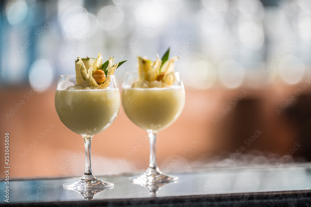 Two cocktails pina colada at barcounter in night club or restaurant Two cocktails pina colada at barcounter in night club or restaurant