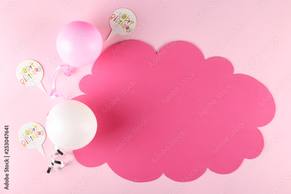 Minimal style composition with different pastel color air balloons with streamer ribbons & blank speech bubble with a lot of copy space for text on pale pink background. Top view, close up, flat lay.