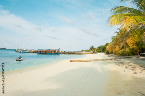 Amazing island in the Maldives , turquoise waters with blue sky background for holiday vacation .