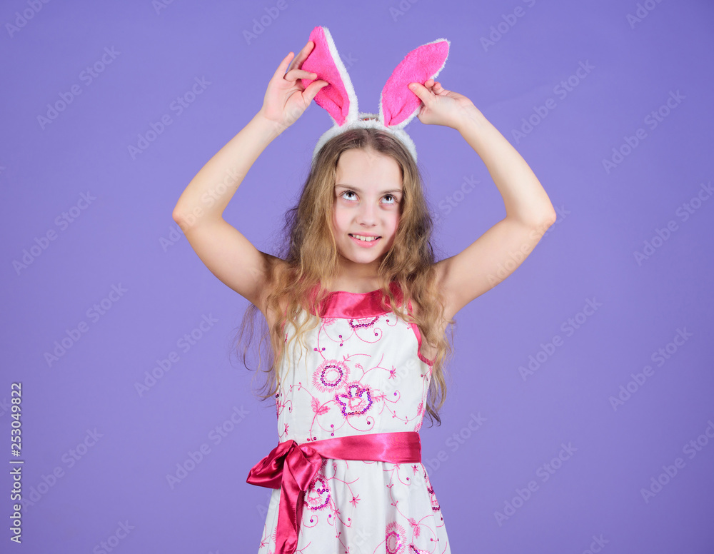 Having such a long ears. Easter bunny concept. Little girl wearing bunny ears. Small girl in bunny headband for Easter celebration. Easter bunny is symbol of Easter