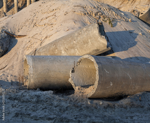 Concrete pipes (tubes) near the sand pile