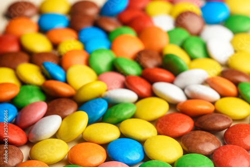Quadro su tela colored round candy scattered on the table close-up
