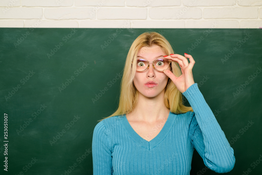Education. Job. People concept. Educational theme. Teacher in glasses. Teacher in clasroom. Portrait of teacher near chalkboard. School. University. College. Back to school. Education. Job. People concept. Educational theme. Teacher in glasses. Teacher in clasroom. Portrait of teacher near chalkboard. School. University. College. Back to school.