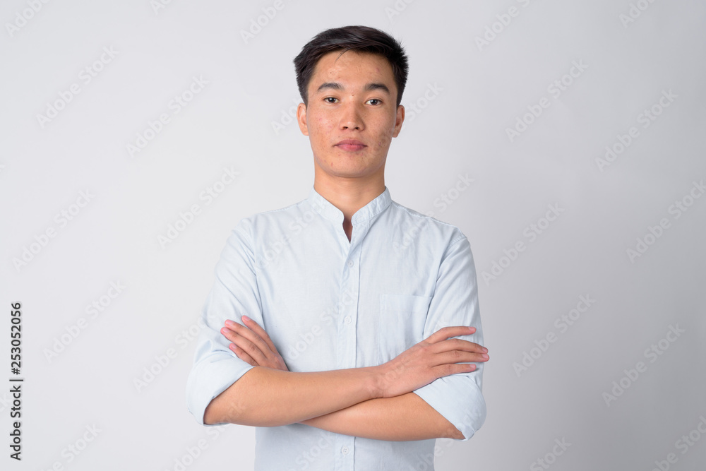Portrait of young handsome Asian businessman with arms crossed Portrait of young handsome Asian businessman with arms crossed