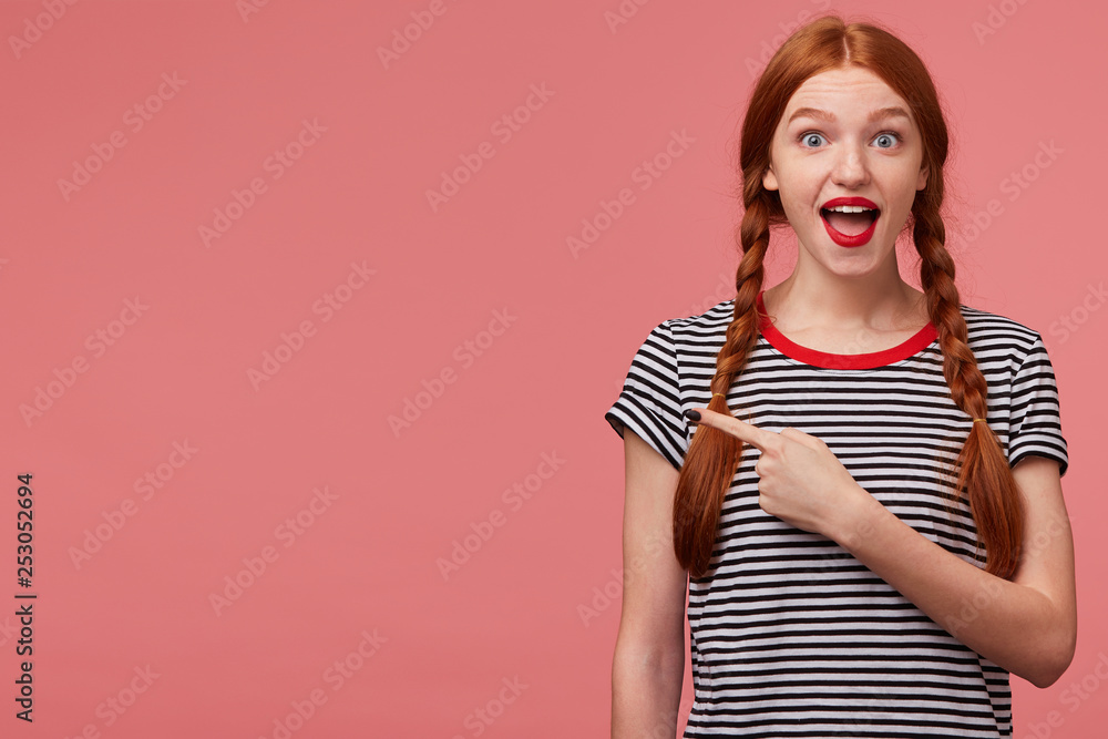 Hey, look, it is great! Happy inspired red haired teen girl shows with index finger on the empty space on left side,is delighted with the product, advises to pay attention,place for your advertisement Hey, look, it is great! Happy inspired red haired teen girl shows with index finger on the empty space on left side,is delighted with the product, advises to pay attention,place for your advertisement